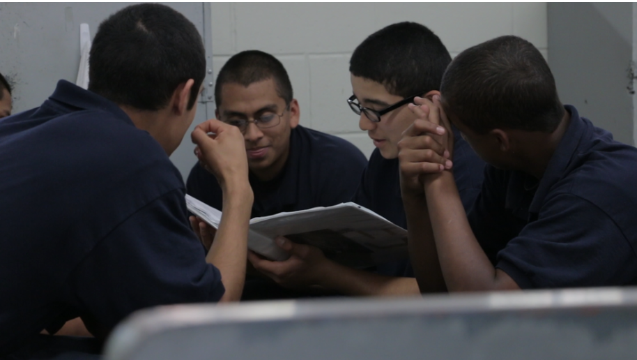 Young men in discussion during a group reading circle